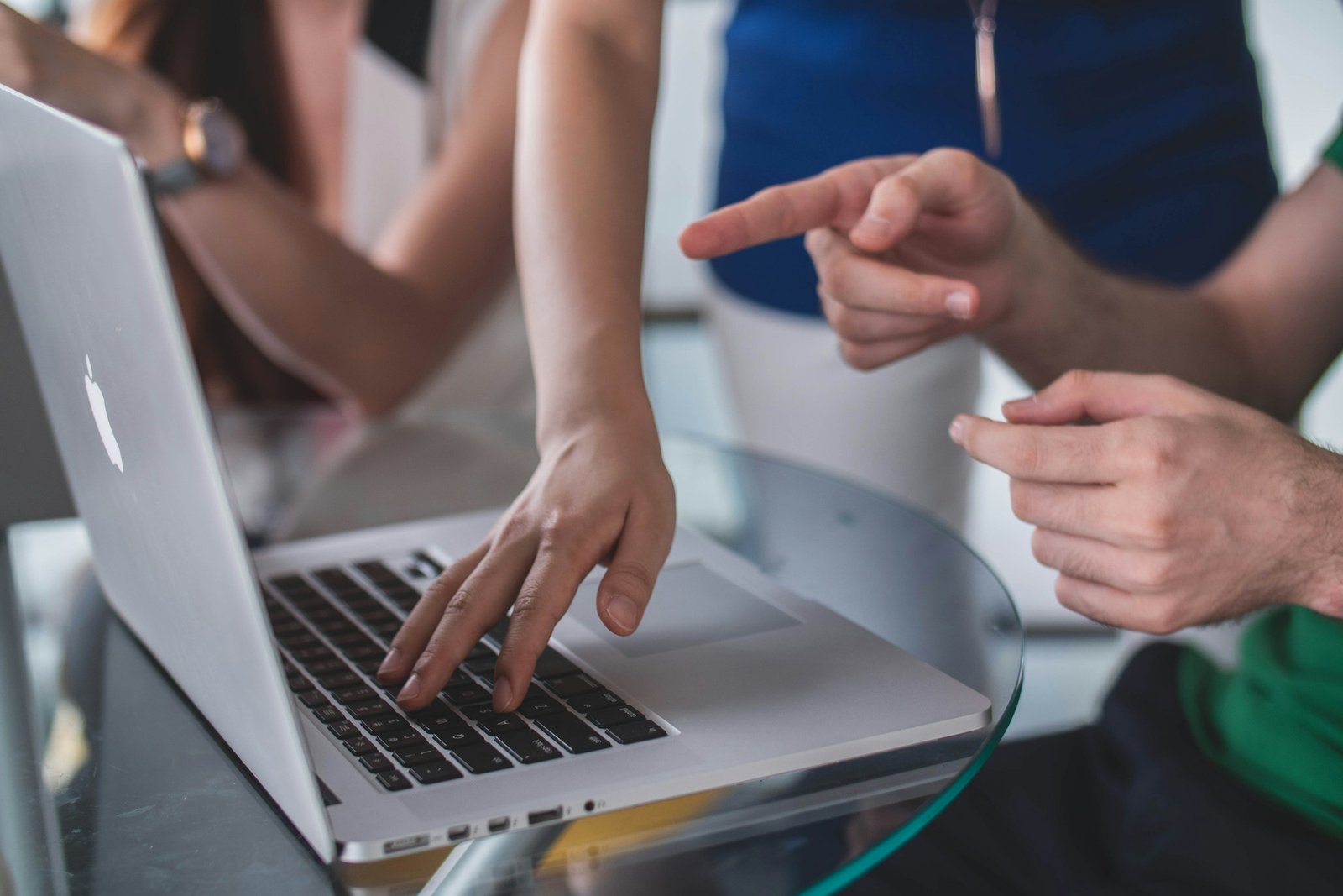 Two people pointing at course options on a laptop