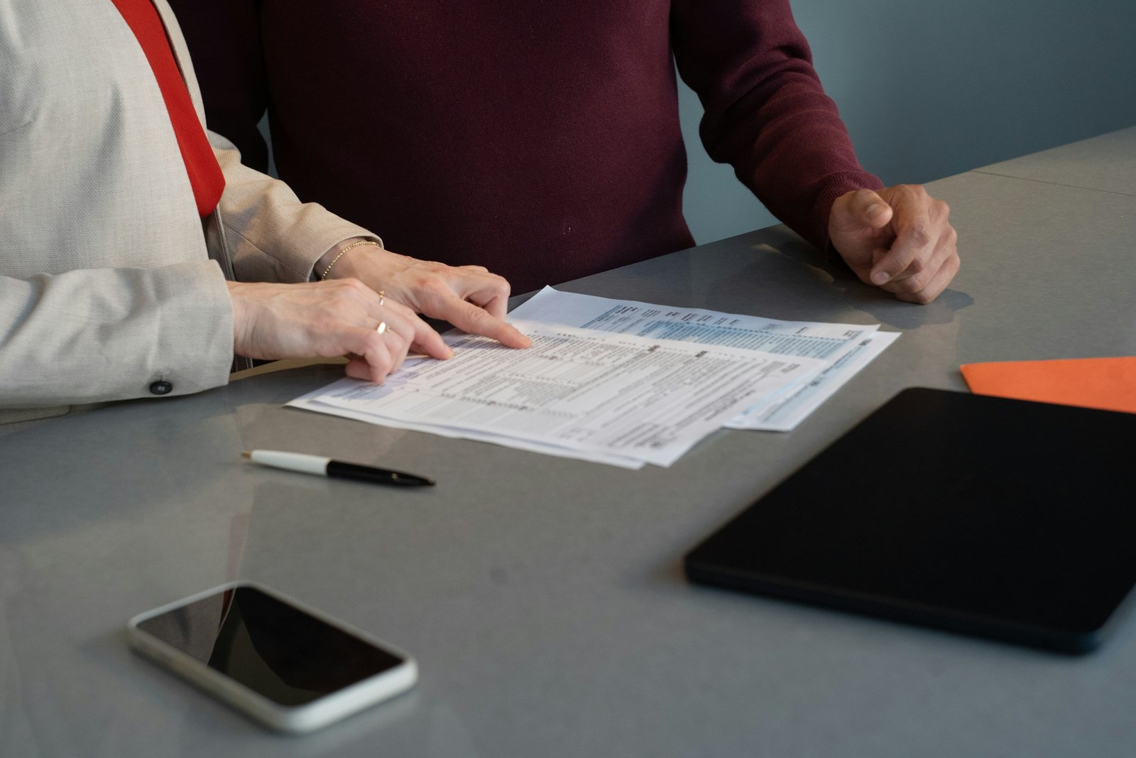 Two people reviewing documents together at a table